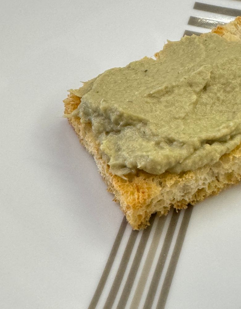 crostino con crema di carciofi su piatto avana